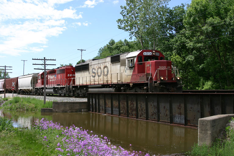 Sooline 6006 & CP 5808
First picture of a train with my new Canon Digital Rebel. Sooline #6006 and CP #5808 head east over the flooded creek in Jenison. 05/26/04 
