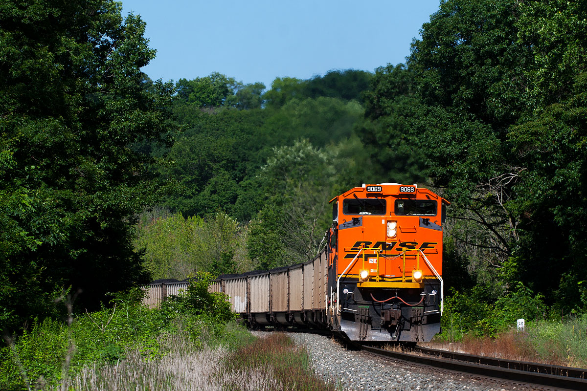 BNSF 9069
D80214 headed down to Wells as lite power to push this N91014 up the curves of Saugatuck Hill. Moving at a decent clip as the headend passed me, but going at a walking speed as the rear pushers went by a few minutes later.  07/18/15 - west of 133rd Ave.
