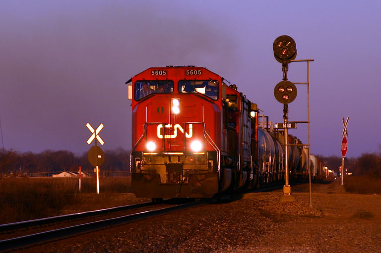 CN 5605 sunset
CN 5605 leads a trio of engines into the setting sun at 10th St in Schoolcraft. 11/13/04 
