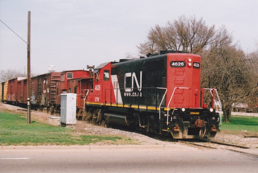 CN GP9R #4626
Canadian National painted GP9R #4626, a former Grand Trunk Geep, pulls the Kalamazoo Switch Run into the crossing at Miller Road. In the background is Cytec, the biggest customer for the CN in Kalamazoo, and one of the busiest rail users in the area. 4626 has in tow the familiar GT wide-vision caboose used on this job, and several cars to take back to Battle Creek Yard. April 17, 2008.
Keywords: Canadian National CN GP9R Kalamazoo Switch Run CN921 Miller Road Cytec 4626 caboose wide vision crossing