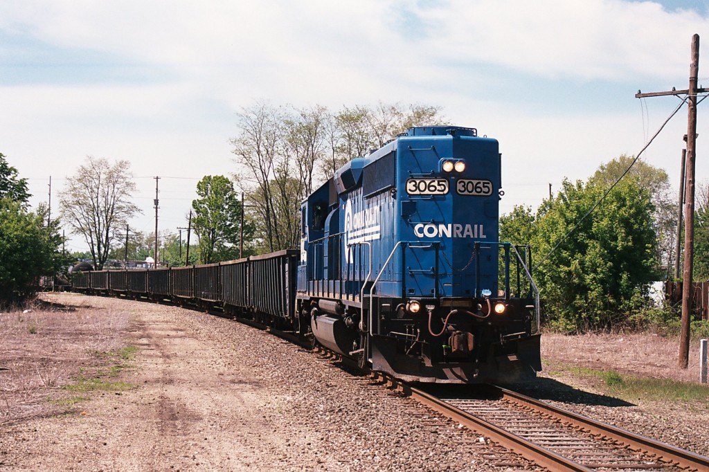 Conrail GP40-2 #3065
Kalamazoo local job B-0-K, the "Pfizer Flyer" makes its southbound trek along the Upjohn Secondary in Kalamazoo.  Power is provided by Conrail painted GP40-2 #3065 this May afternoon.  The train consists of an impressive nine gondolas which will later be spotted and loaded on the junkyard spur near the Michigan Avenue crossing, a tankcar for the Pfizer Portage complex, and a pair of 50' boxcars for another on-line industry.  The train is shown here at the Crosstown Parkway crossing, May 16, 2008.
Keywords: Conrail GP40-2 3065 CR B-0-K Pfizer Flyer Crosstown Kalamazoo gondola scrap code line curve