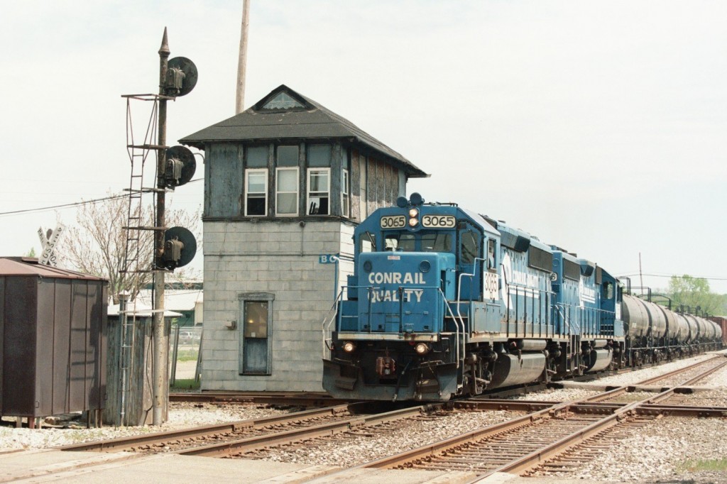Conrail GP40-2 #3065
Twin Conrail GP40-2s led by familiar #3065 lead NS local B-1-G westbound by BO Tower and over the interlocking with a fairly long version of this Tuesday & Thursday train. The consist included the usual cars for Lawton and Dowagiac, along with the first ever load of coiled wire for National Standard in Niles. May 8, 2007. 
Keywords: Conrail CR GP40-2 3065 B1G B-1-G BO tower interlock junction diamond mast signal Kalamazoo
