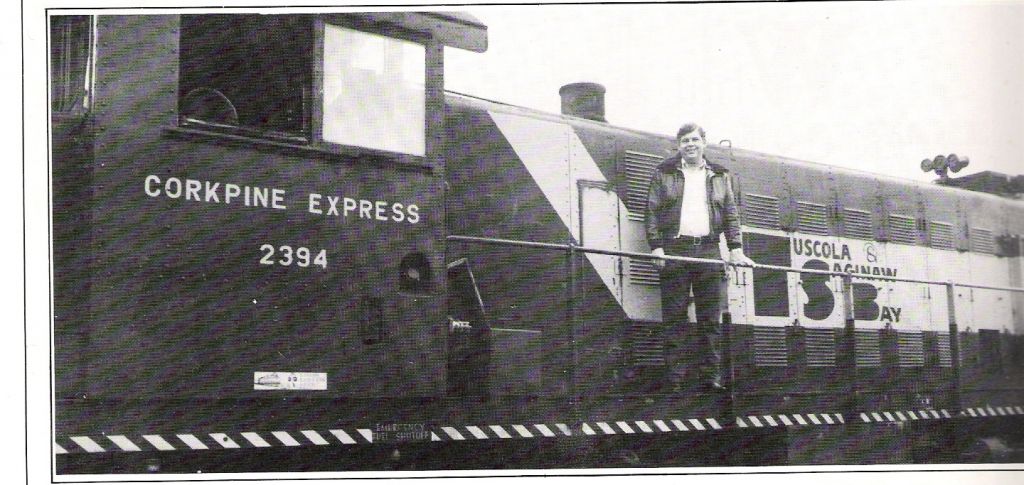 TSBY RS1 2394
Photo of TSBY RS1 2394 taken in the Vassar area with then Vice President of Operations P.J. DeWolf standing on the locomotive. This scan was taken from a late 70's-mid 80's Vassar Chamber of Commerce booklet. 
Keywords: TSBY RS1 2394