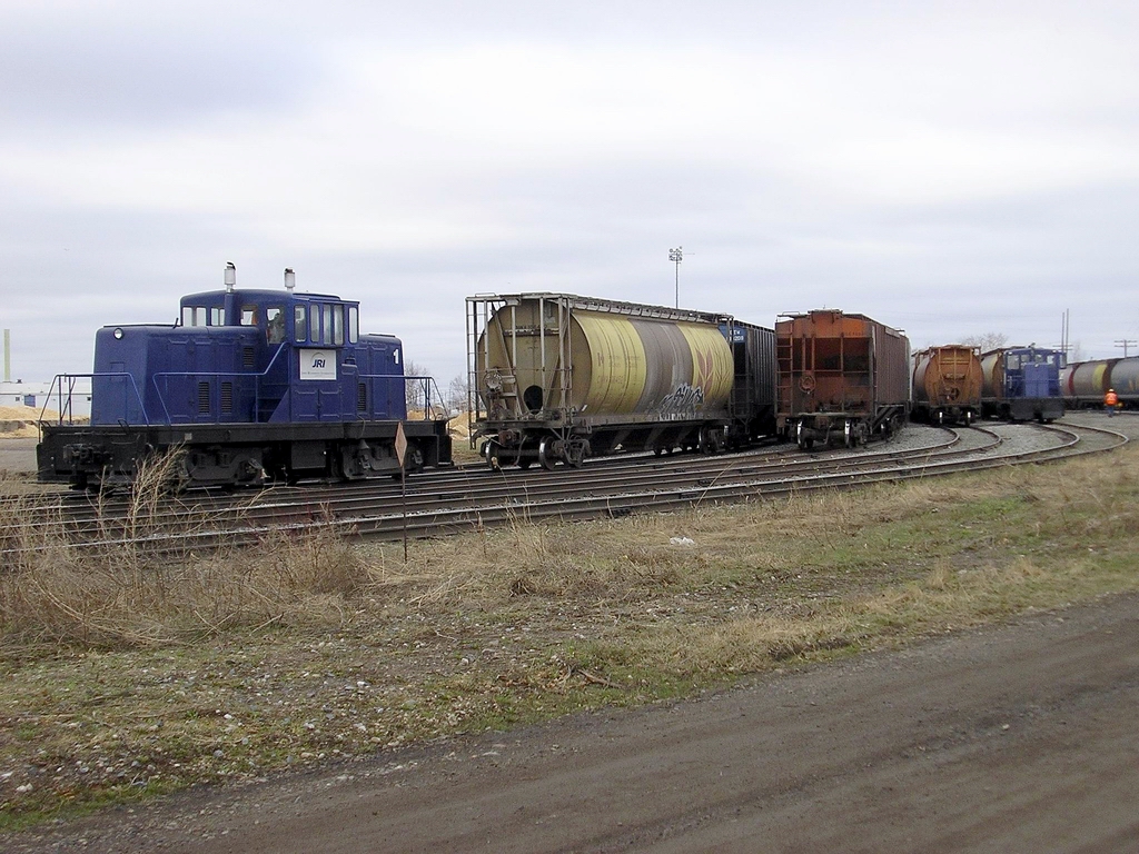 JRI #1 and 2 dropping off empty grain hoppers for the CP at Current River yard near Thunder Bay Apr 20/05
