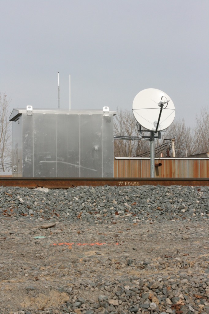 Next Generation ATCS
The new interlockings placed for the North Baltimore project use a satellite link instead of the radio based ATCS link that the existing (from the B&O upgrade project) interlockings do.  As a result, these interlockers cannot be monitored by the ATCS software used by railfans.  Here we see the dish and the Hoytville "A House" on 11/9/2009
Keywords: CSX North Baltimore Intermodal yard Hoytville Ohio