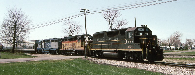 Regular Variety
During the early 1990's it was quite easy to get photos of CSX predecessor road locomotives.  Here GP40 6786 (which has picked up a pair of -2 trucks along the way) in rather worn SCL paint leads a Chessie GP30 and CSX GP40 around the Southeast wye at Deshler on a May 1992 morning.
