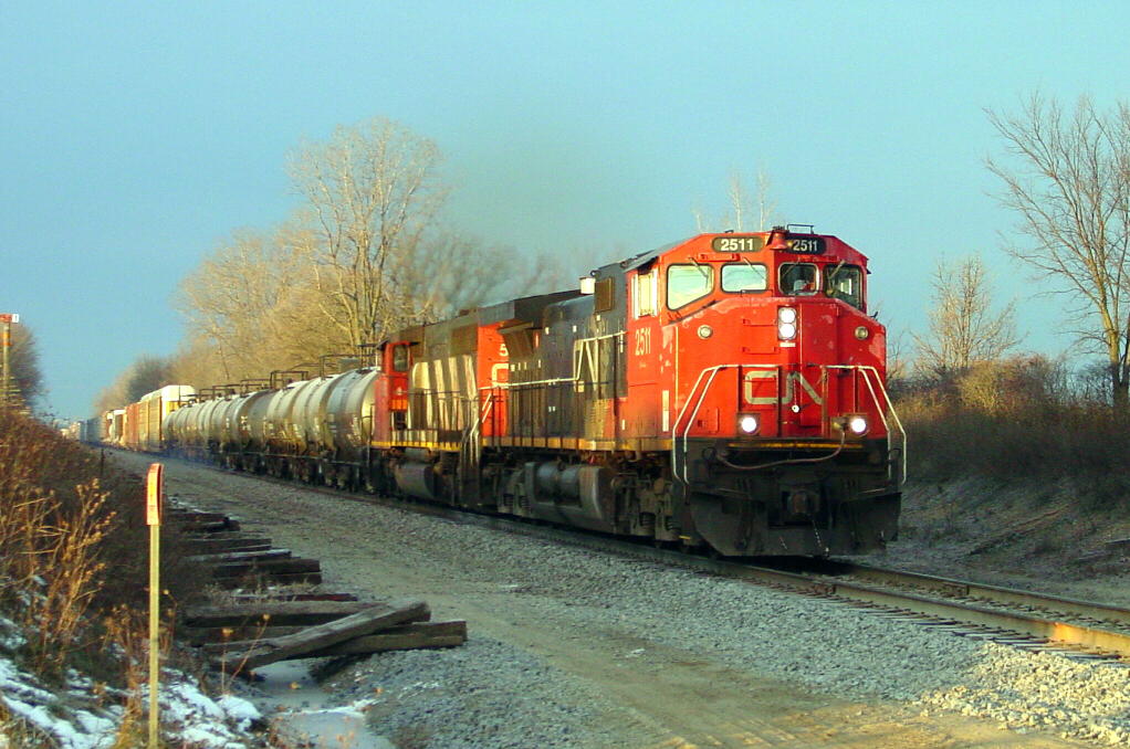 CN 2511 Sheridan
CN 2511 is leading a highball east on the Flint Sub nearing Sheridan Road, just east of Durand.  Notice the frost on the tank cars.  Shot was taken at about 8am on 12/01/07.
