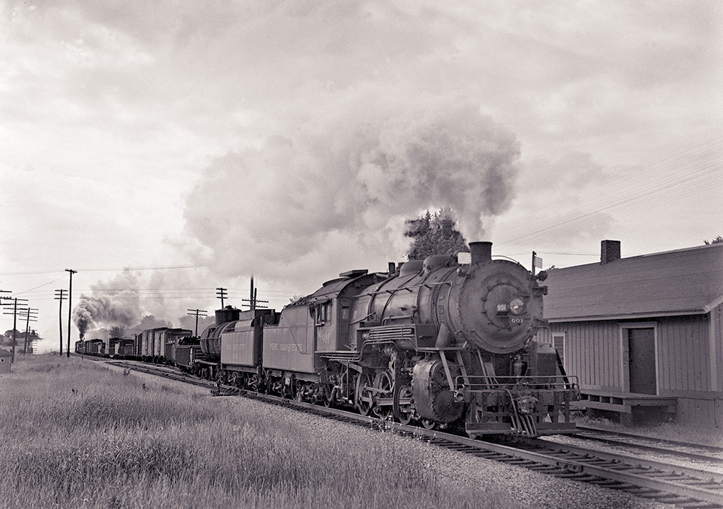 With Assistance
P.M. 901 2-8-0 Getting a boost through Salem,
Michigan with engine 1103 doing the helping.
23 Cars.  Salem, Michigan.
July 22, 1947.
