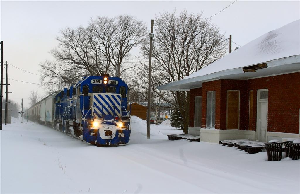 GLC 27 December 2017
Northbound GP-38-2's 396-397 passing the depot in Kalkaska Michigan with traffic for Kalkaska, Elmira and Petoskey in todays consist.
