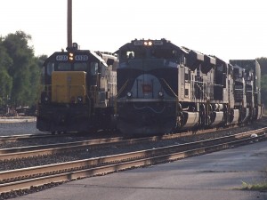 Why yes, they do run trains on these tracks!  Grand Elk on Coach, NS 1070 Wabash passing on Track 2. Backlit. :(