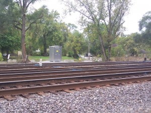 Cabinet at MP.CD-422.4. To the left are the &quot;End Auto Block&quot; signs at the end of North and South Freight. To the right is the first switch signal in the yard (crossover from South to North Freight westbound. The next crossover to the west is between North Freight and the Coach Track (new Track 3). Trains have been passing through CP 423 eastbound on Track 3 and ending up on North Freight through these crossovers.