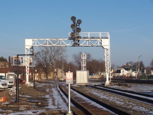 The old signal bridge survives with an Authorized Personnel sign on the old ROW.
