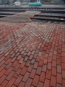 An area of brick infill at center helped to level out what had been a dangerous depression.  How do I know?  I reinstalled the bricks!  An earlier brick repair used slightly higher glazed bricks surrounding.