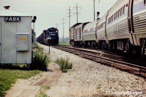 Amtrak detour train at( MP33) CP Park on the Kalamazoo Branch. Southbound train #353 in the hole for northbound CR freight to Kalamazoo. June 6th 1983.