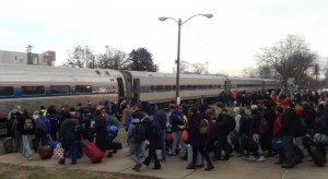 The crowd descends in two lines after the train has stopped.