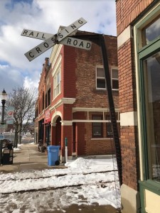 This home-made crossbuck still guards the sidewalk and road at Grand River Avenue in Old Town. Beyond the track, the first building with the arched overhang is the headquarters of the Michigan Historic Preservation Network, a non-profit dedicated to helping historic neighborhoods such as Old Town, and their unique built environment, thrive. More info at mhpn.org.