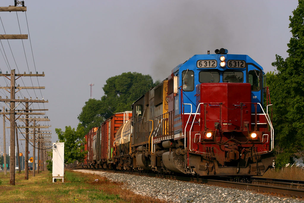 Q326 with HLCX 6312
This pair has been running back and forth along the CSX Michigan lines for a bit now.  HLCX 6312 and CSXT 8581 on CSX Q326 head east through Hudsonville.  07/03/06
