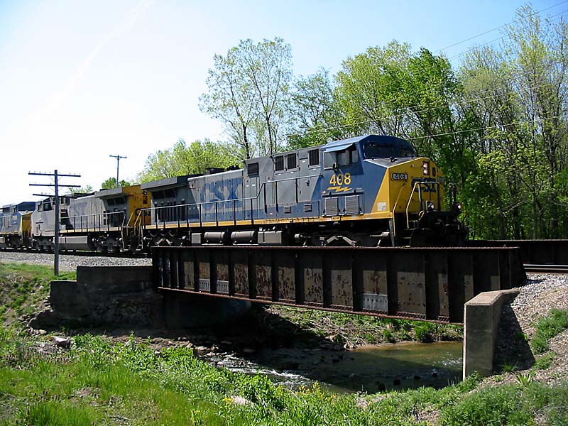 CSX 408
CSX #408 heads east in Jenison over a normal water leveled creek with empties from the West Olive power plant. 05/07/04 
