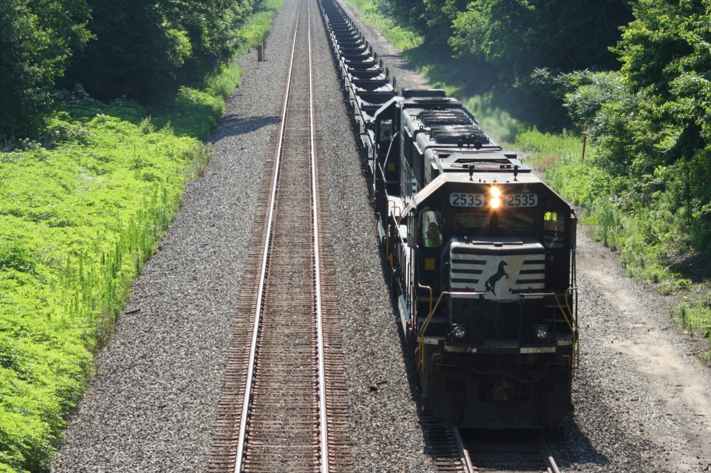 NS 2535 leads empty coil cars west of Pinola, IN July 6, 2011
