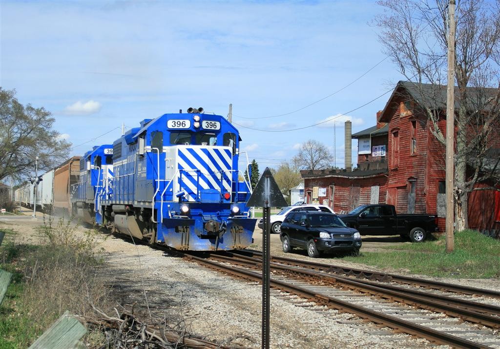GLC 6 May 2015
396 leads 398 and a short train of empty plastic pellet cars southbound past the historic feed mill in Kalkaska.
